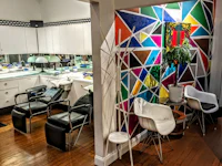 a salon with colorful chairs and a colorful wall